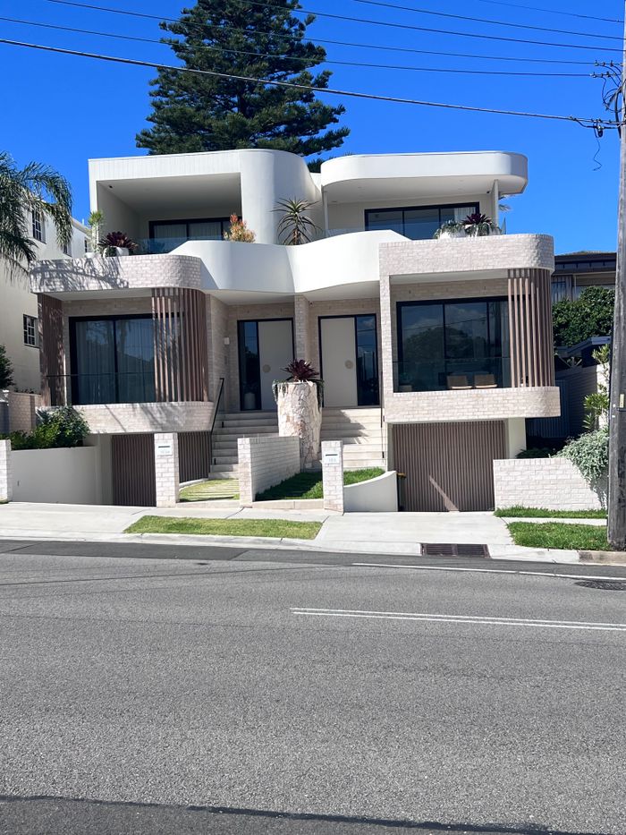 our-experience Contemporary coastal home featuring modern architecture in a sunny, suburban setting.