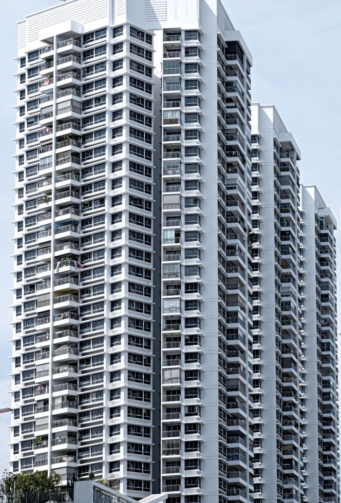 about-02 A towering modern high-rise apartment building with a concrete facade.